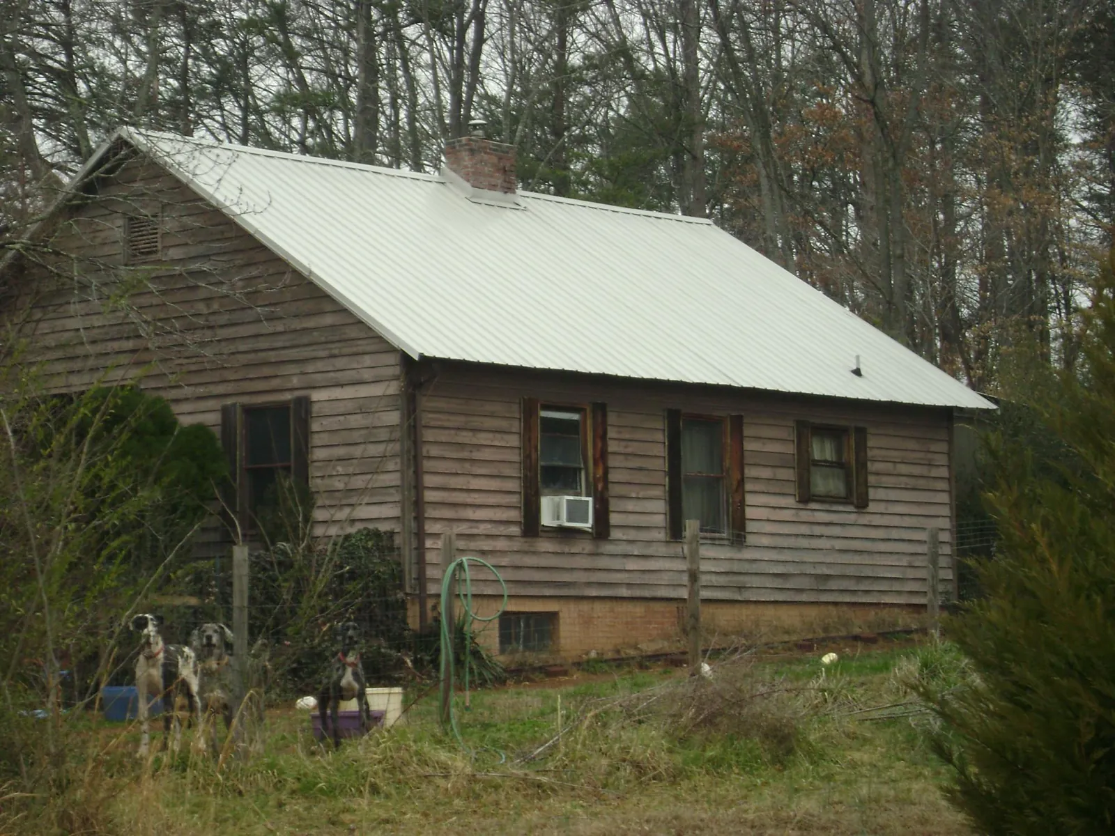 White metal roof on an old wood sided farmhouse, from a Asphalt Shingle Roof Repair job in Newport News